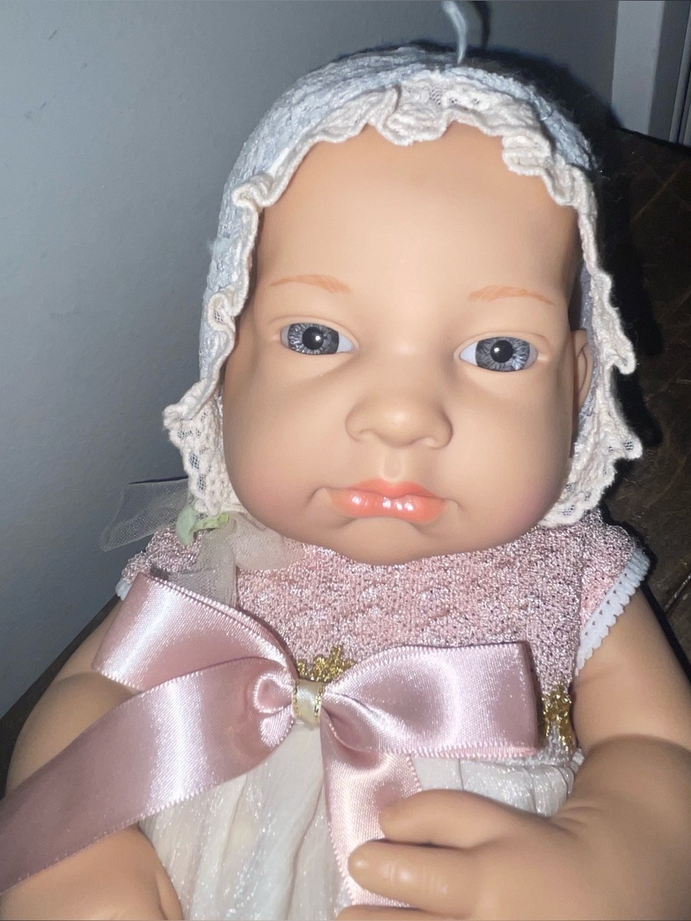 Baby So Lovely realistic newborn baby doll wearing a lace-trimmed bonnet